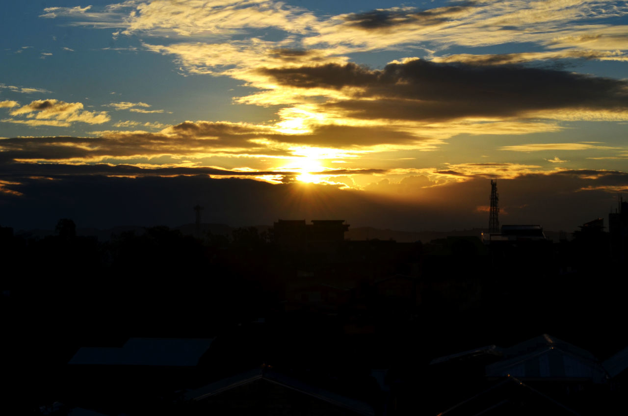 SILHOUETTE CITYSCAPE AGAINST SKY AT SUNSET