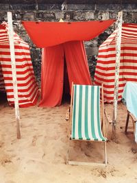 High angle view of deck chair and tents on beach 