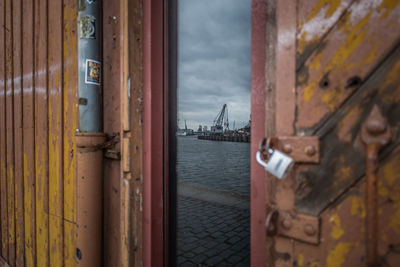 View of boats in sea against cloudy sky