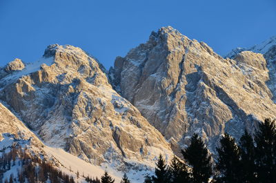 Panoramic view of snowcapped mountains against clear sky