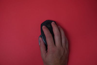 Close-up of human hand against red background