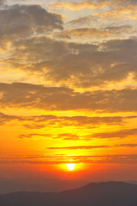 Scenic view of dramatic sky during sunset