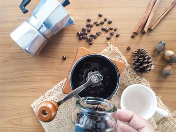 High angle view of hand holding food on table
