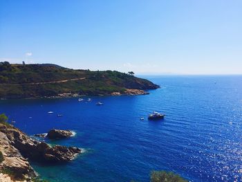 Scenic view of sea against clear blue sky