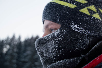 Close-up of man looking away during winter