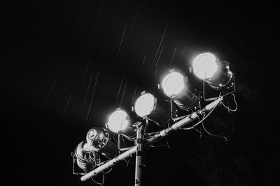 Low angle view of illuminated lights at night