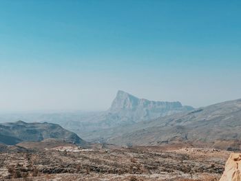 Scenic view of desert against clear blue sky