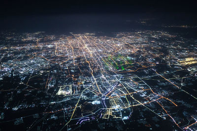 High angle view of illuminated city buildings at night