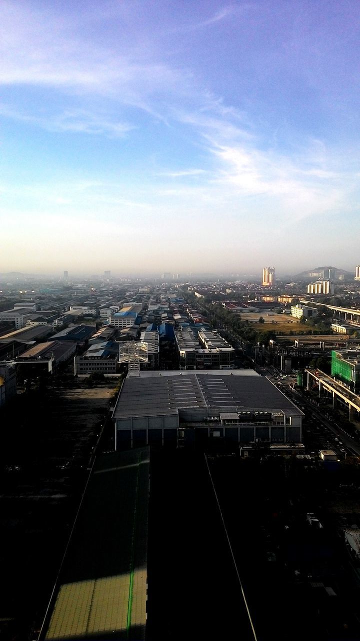 building exterior, architecture, cityscape, city, built structure, high angle view, sky, crowded, residential district, city life, cloud - sky, residential building, residential structure, cloud, outdoors, no people, aerial view, elevated view, roof, day