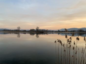 Scenic view of lake against sky during sunset