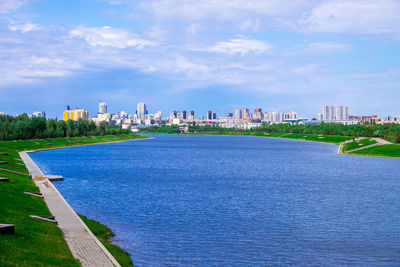 Scenic view of swimming pool by buildings against sky