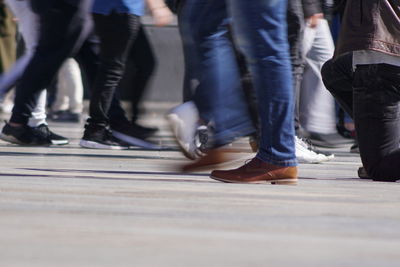 Low section of people walking on street