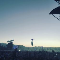 Low angle view of crowd against clear sky