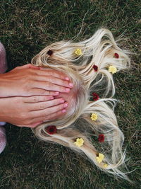 High angle view of hand feeding on field