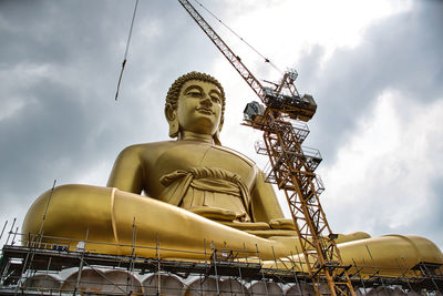 Low angle view of statue against sky