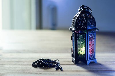 Close-up of illuminated lamp on table