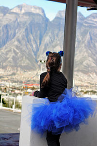 Rear view of girl looking at mountains