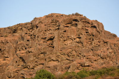 Low angle view of rock formations against sky