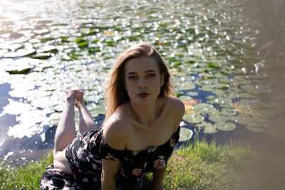 Portrait of beautiful young woman in water