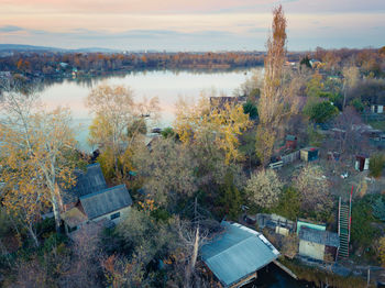 High angle view of trees by lake against sky