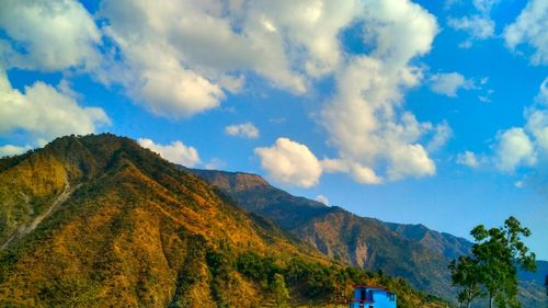 Scenic view of mountains against blue sky