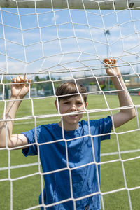 Boy standing on soccer field