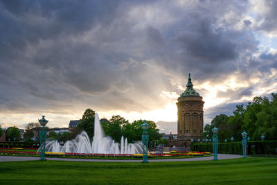 View of cityscape against cloudy sky