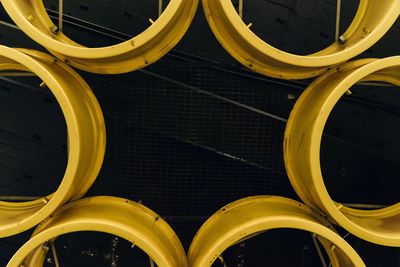 Yellow metal structure hanging on ceiling at subway station