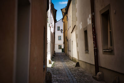 Narrow alley amidst buildings in town