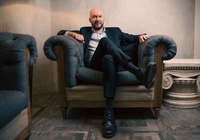 Portrait of businessman sitting on chair