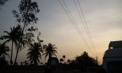 Low angle view of power lines against sky