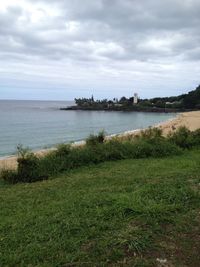 Scenic view of sea against cloudy sky