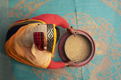 Woman cleaning food grain 