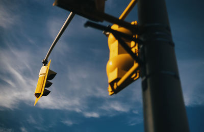 Low angle view of yellow pole against sky