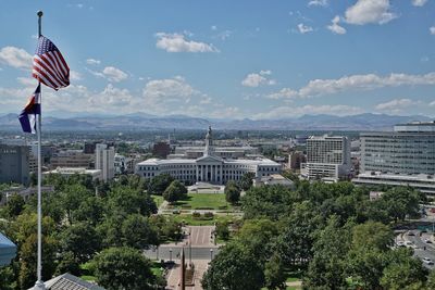 Trees and city against sky