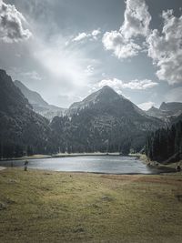 Scenic view of lake and mountains against sky