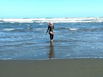 Full length of man on beach against sky