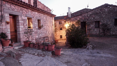 Old building by street against clear sky