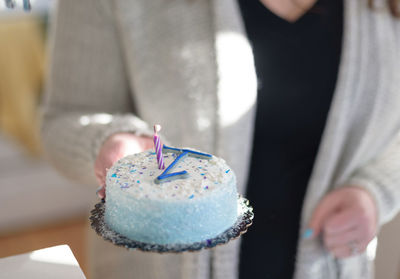 Close-up of hand holding ice cream