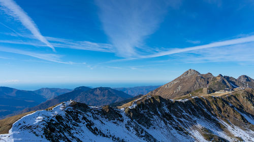 Scenic view of snowcapped mountains against blue sky