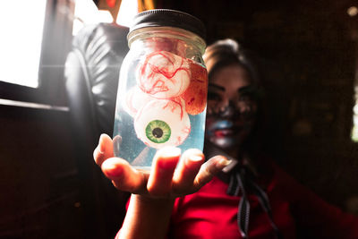 Close-up of girl holding jar