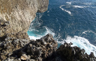 High angle view of rock formations by sea