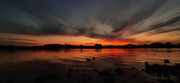 Scenic view of lake against sky during sunset