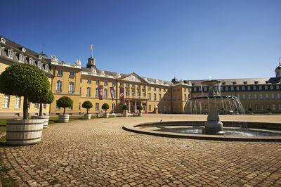 View of buildings against clear blue sky