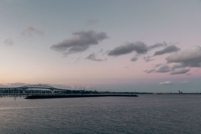 Bridge over river against sky during sunset