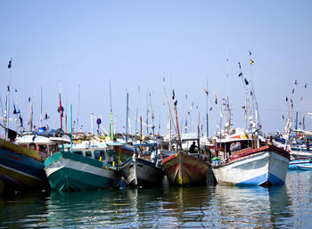 Boats moored at harbor