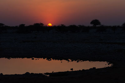 Scenic view of silhouette land against sky during sunset
