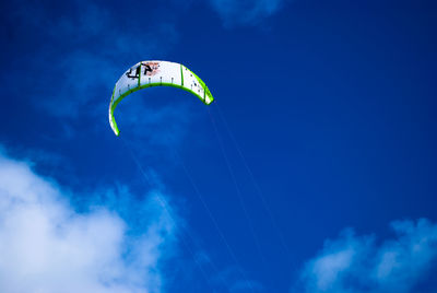 Low angle view of parachute against blue sky