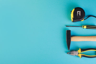 Tools worker, hammer, screwdriver, pliers on a blue background, top view