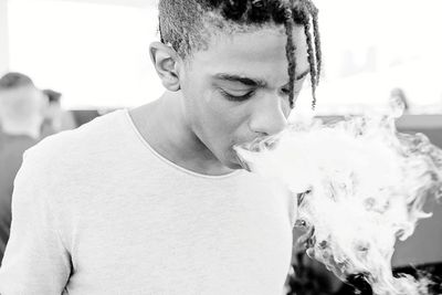 Portrait of young man holding camera